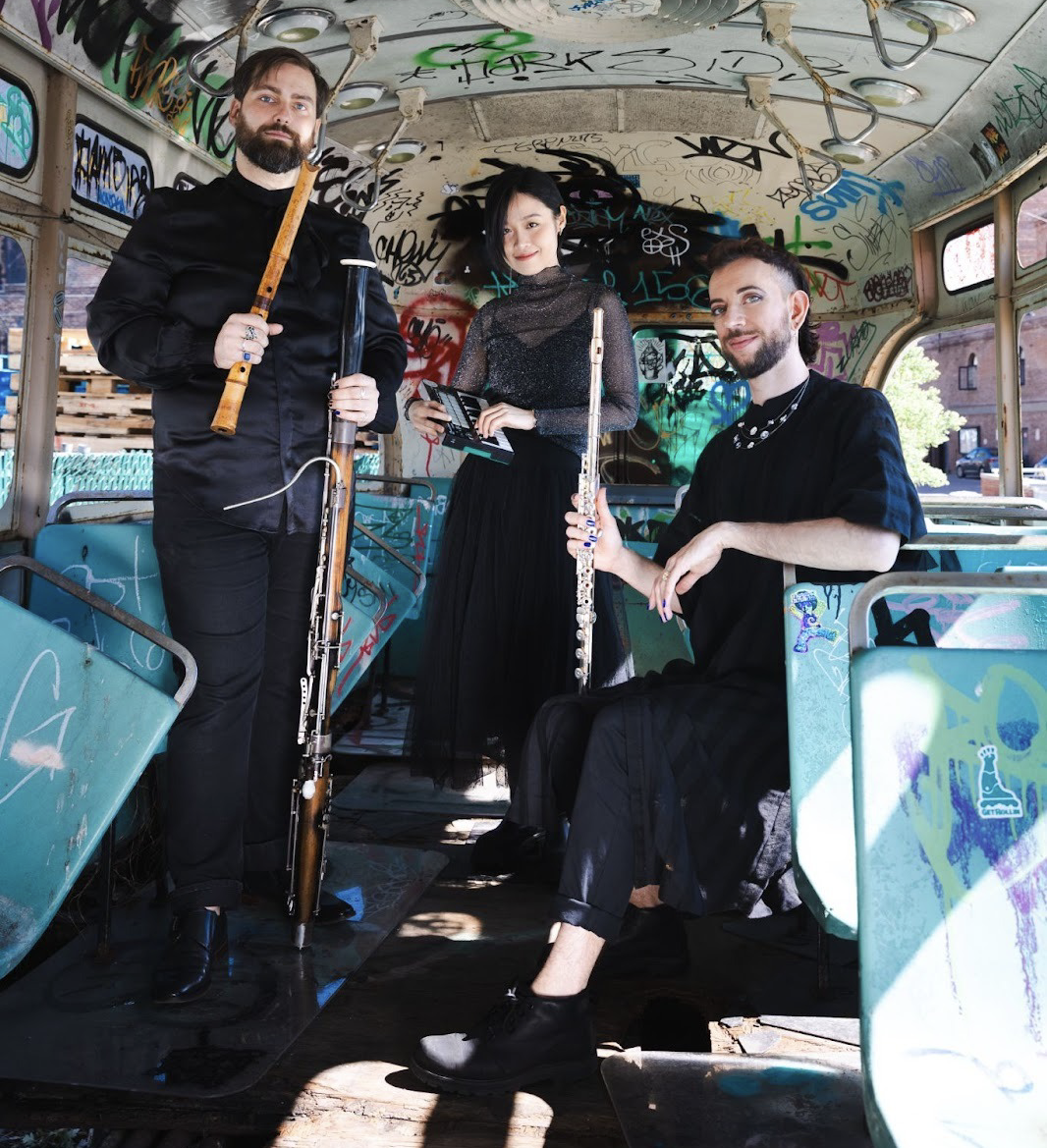 Apply Triangle ensemble portrait on a graffiti-covered bus